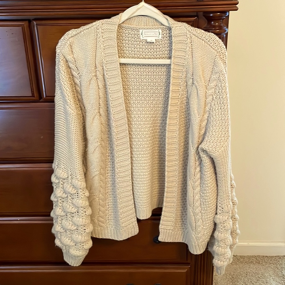 Cream colored cardigan. Medium